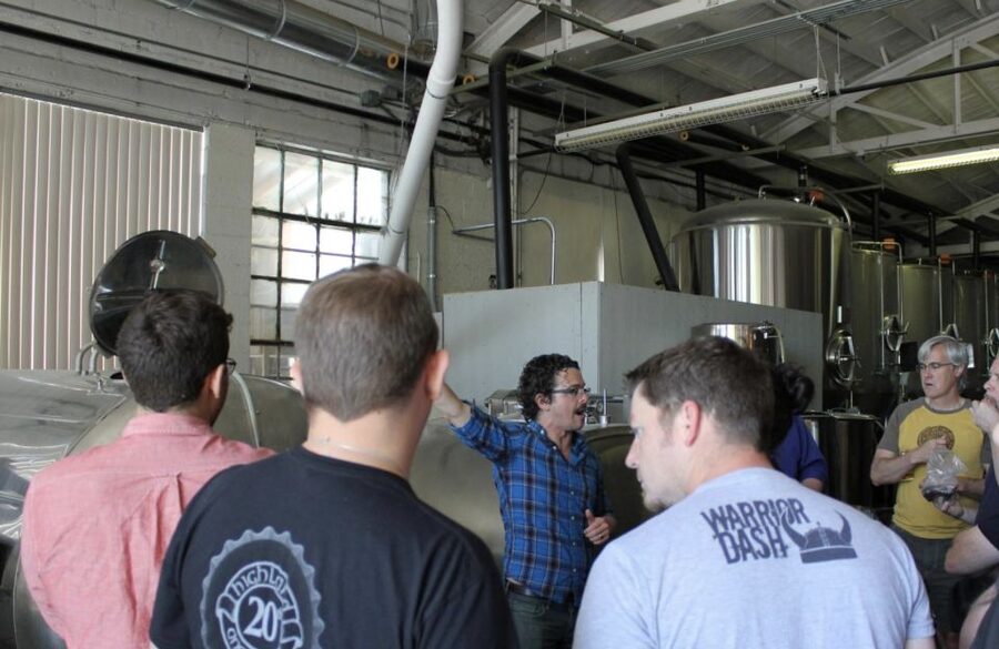 Asheville: Expert-Led Brewery Walking Tour with Beer Samples - Entering a brewery production area